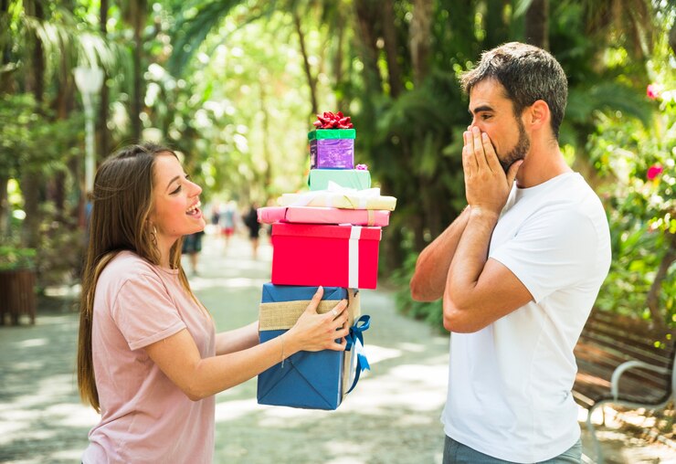 woman-giving-stack-gifts-her-surprised